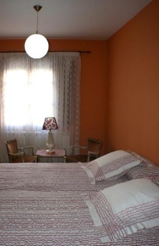 a bedroom with a large bed and a window at La Casa del Reloj in Enciso