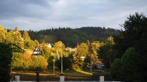 a town with trees and a fence in the foreground at Chata w Rabce - Bajkowa Osada in Rabka