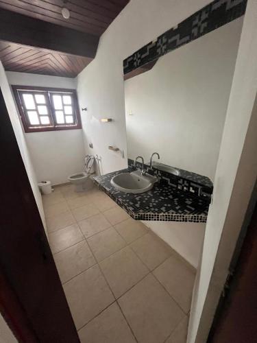 a bathroom with a sink and a toilet at Casa Country Niterói in Niterói