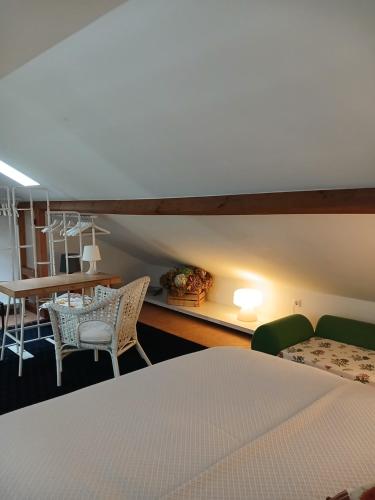 a bedroom with a bed and a table and chairs at A Casa da Vila in Alcochete