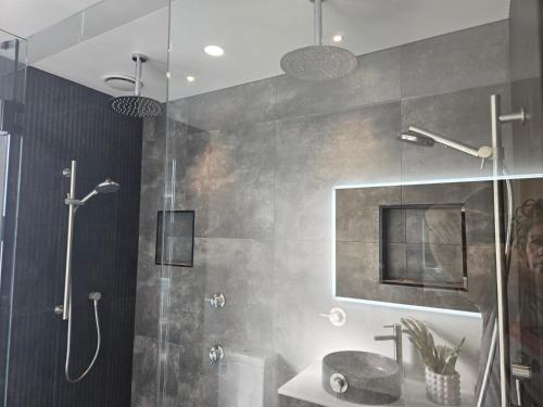 a bathroom with a shower and a sink at Pakawau Princess in Pakawau