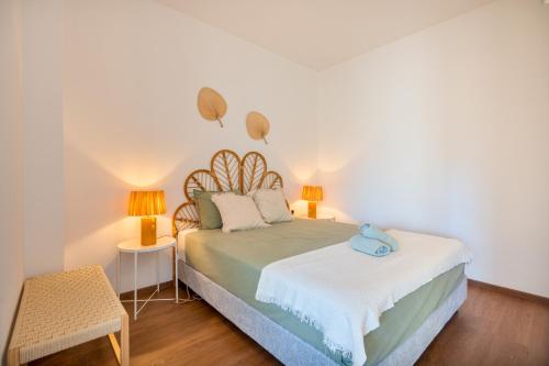 a bedroom with a bed with two lamps on it at Ocean View - XL Terrace - Beachfront by Tenório in Lagos