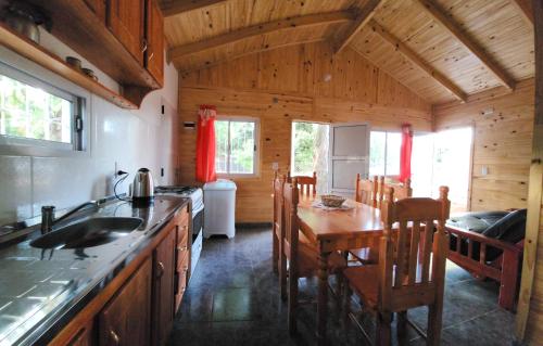 a kitchen with a table and a dining room at Yacaré INN in Ituzaingó