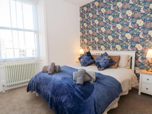 a bedroom with a bed with stuffed animals on it at The Penthouse at 86 in Rossendale