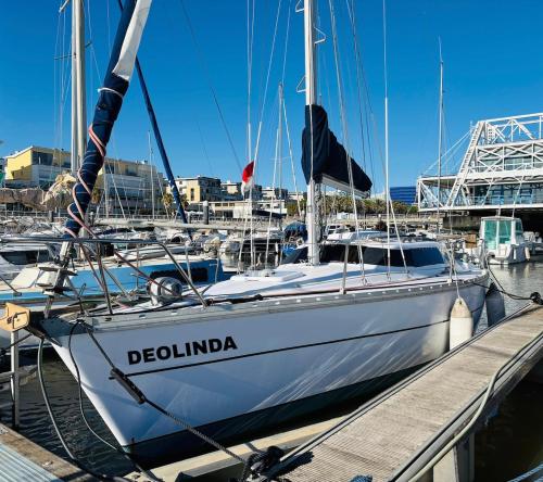 a boat docked at a dock in a harbor at Deolinda Charming Boat Stay at Oriente Marina in Lisbon