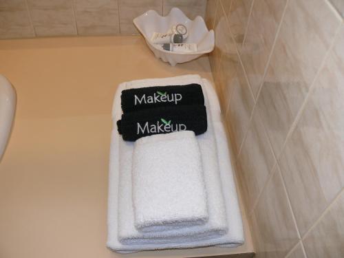a bathroom with a white towel with a make up sign on it at Milawa Motel in Milawa
