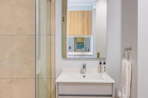 a bathroom with a sink and a shower at Ellipse Soleya in Midrand