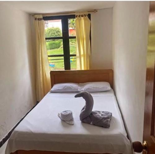 a bedroom with a bed with a swan on it at Hotel El Molino in Estación El Salto