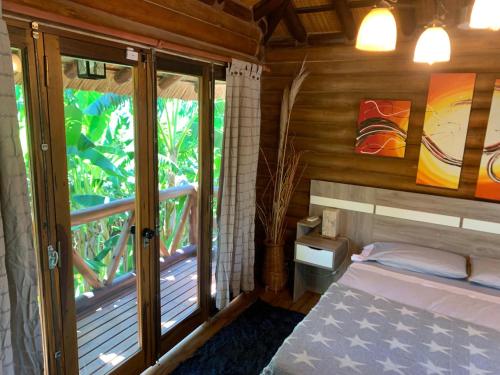 a bedroom with a bed and a balcony at Espacio Natural in Gualeguaychú