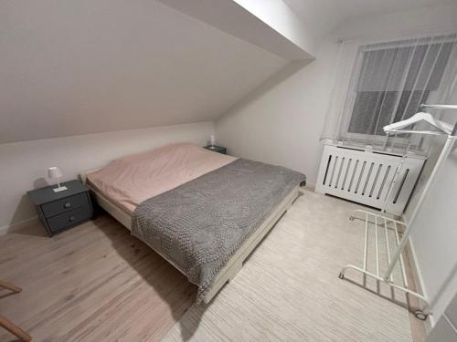 a small bedroom with a bed and a window at Duplex House - Private Home MUNA in Sarajevo