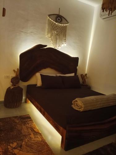 a bedroom with a bed and a chandelier at Sina Cave in Dahab