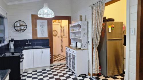 a kitchen with a refrigerator and a stove top oven at Cheerful 3 bedroom villa in Gisborne