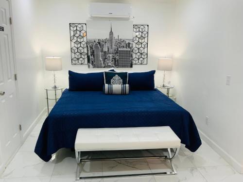 a bedroom with a blue bed with a bench at My Dream Space in Orange Park