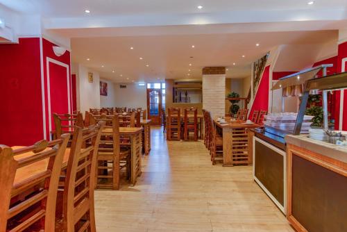 a dining room with wooden tables and chairs at New Promenade Hotel in Blackpool