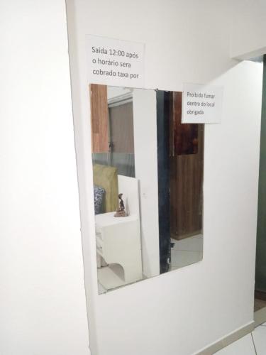 a mirror on a wall in a room at casas praias familiar in Piçarras