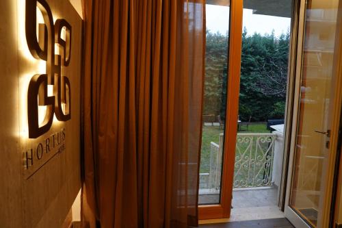 an entrance to a door to a balcony with a glass door at Hortus Hotel Tirana in Tirana