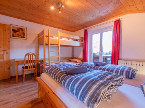 a bedroom with a bunk bed and a desk at Pehambauer S in Hüttau