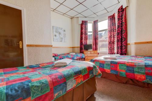 מיטה או מיטות בחדר ב-New Promenade Hotel