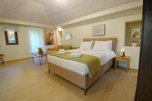 a bedroom with a large bed and a couch at Raise Polydrosos Traditional Getaway in Polydrossos