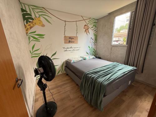 a bedroom with a bed and a camera in a room at Doce lar da Be in Ribeirão Preto