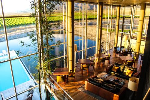 a view of a room with a large glass wall at Casa de Uco Vineyards and Wine Resort in Los Árboles