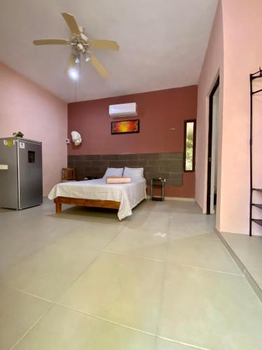 a bedroom with a bed and a ceiling fan at Casa Tio 1,quiet ground floor apartment in El Cuyo