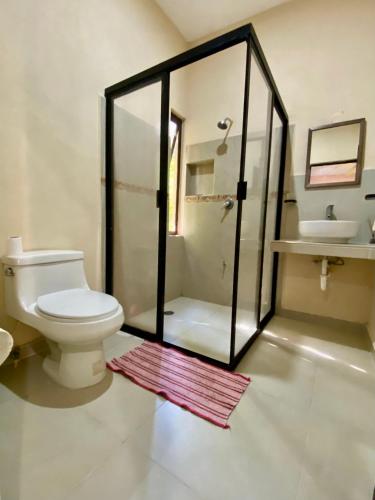 a bathroom with a shower and a toilet and a sink at Casa Tio 1,quiet ground floor apartment in El Cuyo