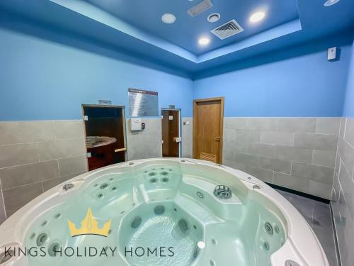 a jacuzzi tub in a bathroom with blue ceilings at Central Park towers residence difc in Dubai
