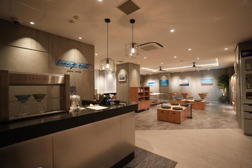 a kitchen with a counter and a living room at Tokyu Stay Shibuya in Tokyo