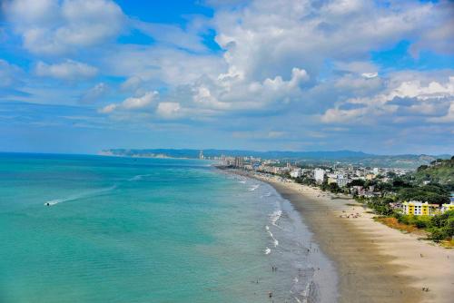 a view of a beach with a city and the ocean at Hotel La Barca in Atacames