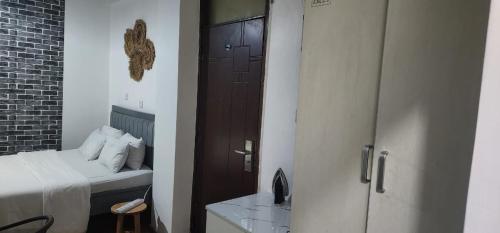 a bedroom with a bed and a door to a room at Mardley Suites in Nairobi