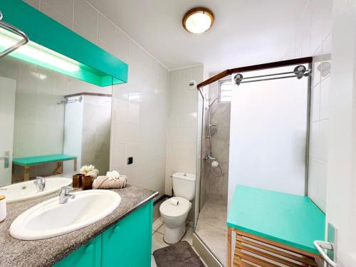 a bathroom with a sink and a toilet and a shower at Private beach access, fiber optic internet & parking in Punaauia