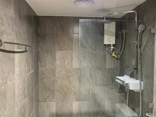 a bathroom with a shower and a sink at Hotel Kaya Puerto Galera in Sabang