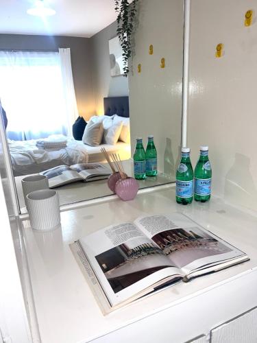 a counter with an open book and bottles of water at u5-Traditional QLD unit with backyard-Fresh-Quiet Leafy Centre-NewAC SmartTV in Brisbane