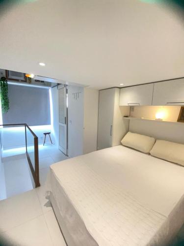 a bedroom with a large white bed in a room at MATER Vila Borges in Rio de Janeiro