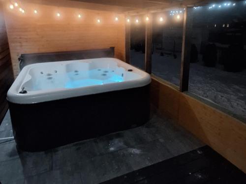 a large bath tub in a room with lights at Miłe Zacisze in Karpacz