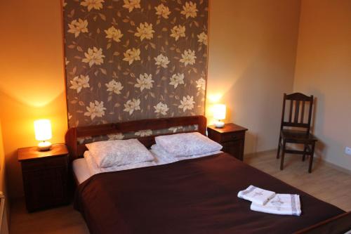 a bedroom with a bed with two towels on it at Domek Na Prowincji in Nałęczów