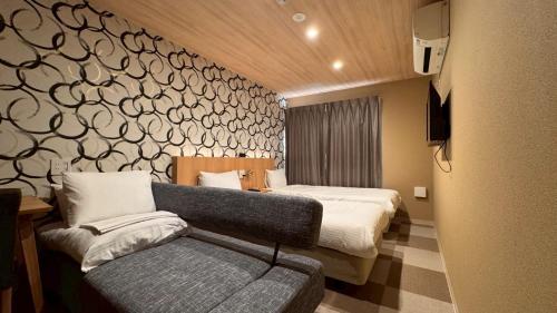 a hotel room with a bed and a couch at HOTEL THE POINT Kiyomizu Gojo in Kyoto