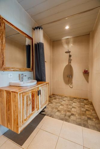a bathroom with a sink and a mirror at Goutama Homestay in Ubud