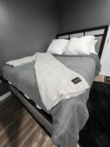 a bed with a blanket and pillows on it at Comfortstayrus in Orange