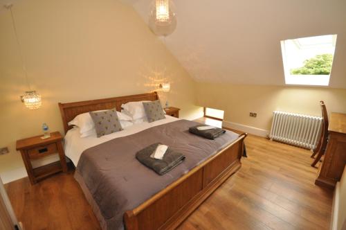a bedroom with a large bed and a window at Hastings Barn in Bideford