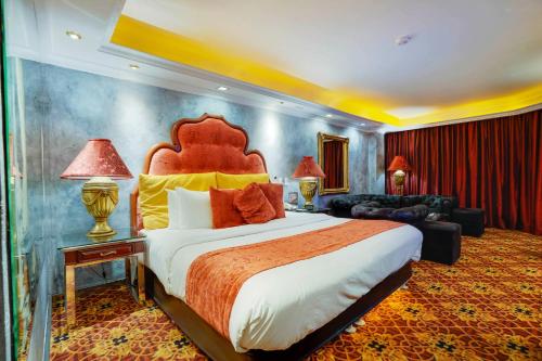 a bedroom with a large bed and a couch at ABC Entertainment Resort in Angeles