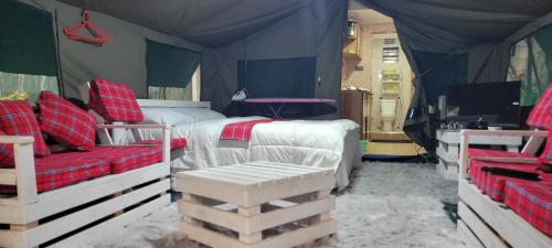 a bedroom with a bed and a couch in a tent at Destiny Paradise in Amagoro