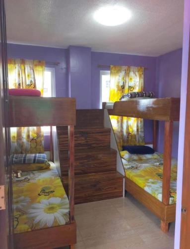 a room with three bunk beds in a room at Harmony Mines in Baguio