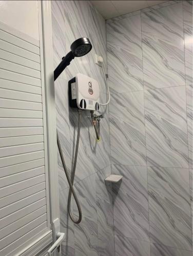 a shower in a bathroom with a blow dryer at Harmony Mines in Baguio