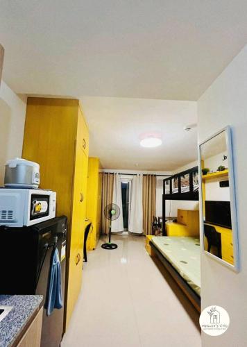 a small kitchen with a bunk bed in a room at Bernwood Tower IloIlo - Heavens Crib in Iloilo City