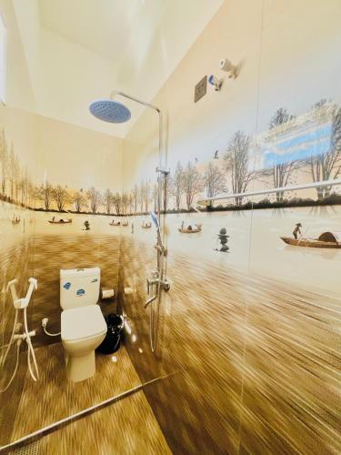 a bathroom with a shower and a toilet in it at Messiah Royal Residence in Negombo
