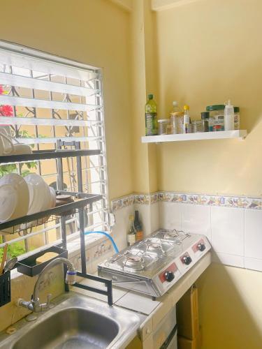 a kitchen with a sink and a window at Uong Oasis in San Salvador