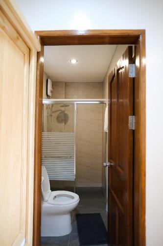 a bathroom with a toilet and a walk in shower at Olana Bed and Breakfast in Labrador