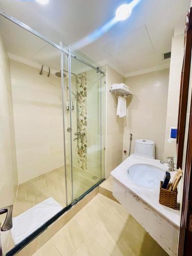 a bathroom with a shower and a sink and a toilet at Air Star Hotel in Ho Chi Minh City
